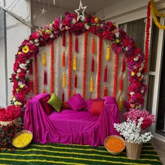 A beautiful seating arrangement for a Mehndi or Sangeet ceremony. I used a floral arch in shades of pink and red, with a comfortable sofa covered in bright pink fabric for the bride.