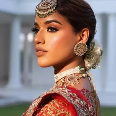 A close-up on classic bridal beauty. I styled this look with a statement maang tikka and matching earrings to accentuate the intricate silver and red embroidery of the lehenga.