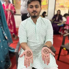 Mehendi for the groom. A simple design with the couple's initials and a portrait of his bride. Grooms deserve some henna love too.