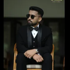 The classic black tuxedo, redefined. This bespoke three-piece suit is crafted from premium fabric, featuring satin lapels and a tailored fit that ensures a sharp, timeless look for any formal occasion.