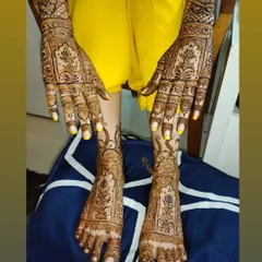 A beautiful example of matching hand and foot bridal mehndi. The design features traditional motifs that flow seamlessly from the arms down to the toes.