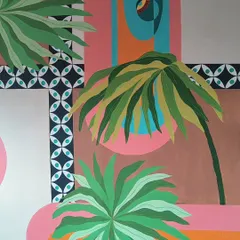 A detail from a mural that combines tropical leaves with geometric patterns and bold colors. This fusion of styles creates a really dynamic and modern look.