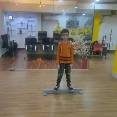 Training starts with the fundamentals. Here, a young student practices a balance exercise on a beam, a key drill we use to build core stability and a steady stance, which is crucial for accurate shooting.