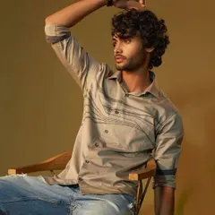 A relaxed and casual portrait of a male model. The grooming is minimal and natural, perfect for a daytime event or a pre-wedding shoot, ensuring the skin looks even and fresh without any visible makeup.