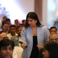 Moving through the audience during an interactive segment. This is a great way to make a large room feel intimate and encourage participation.