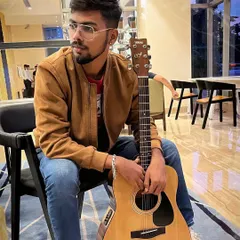 Taking a quiet moment with my guitar before a gig. The time before a show is for focus and preparation, ensuring I'm ready to give my best to the audience.