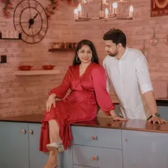 A cozy and stylish shot in our modern kitchen set. The bride's satin dress and the warm lighting create an intimate and chic pre-wedding photo.