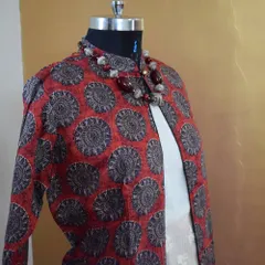 An angled view of the red and black printed jacket, highlighting the mandarin collar and the rich texture of the poly-silk fabric.