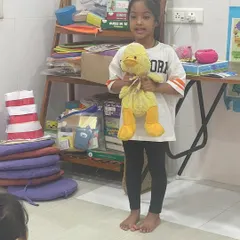 This student chose her favorite stuffed duck for "Share and Shine." Bringing a personal object helps children feel more confident and gives them a clear topic to talk about.