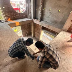 This high-angle shot captures the initial site observation. I am assessing the double-height space and the large circular window, planning how to use these unique architectural features to create a dramatic and light-filled interior.