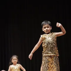 It's not just for girls. This young man from the 'Little Champs' group shows off his powerful moves and stage presence during the performance.