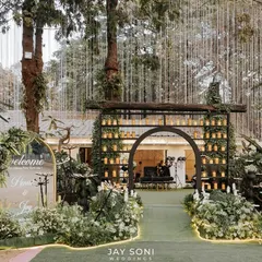 This engagement ceremony entrance was designed to be nothing short of extraordinary. A candle-lined archway, a mirrored welcome sign, and whimsical flower lights created a magical pathway for guests.