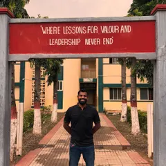 Standing at the entrance of my school, under the sign: "Where lessons for valour and leadership never end."