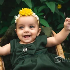 The pure, uncontainable joy of childhood captured during an outdoor session. I love using natural settings and warm sunlight to create vibrant, happy portraits like this one, where your child's personality can truly shine.