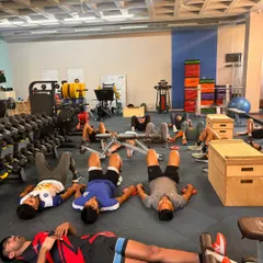 A wider view of a breathwork session with the team. Teaching athletes to breathe deeply and efficiently is fundamental for nervous system regulation and managing fatigue during a long season.