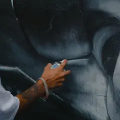 A shot of my hand, showing the spray can control needed to create the soft shades and gradients on the black and white portrait of Rohit Sharma.