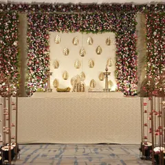 The full view of the stage, showcasing the symmetry and balance of the design. The traditional brass lamps on stage add an authentic South Indian touch to the elegant setup.