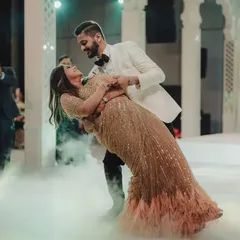 A fairytale first dance. The couple is enveloped in a low-lying fog effect on the dance floor, perfectly complementing the grand, romantic atmosphere of their engagement celebration.