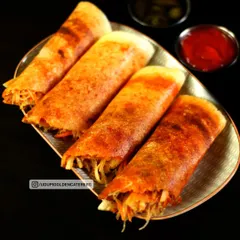 Crispy spring vegetable dosas, filled with a fresh mix of shredded vegetables and spices. This modern twist on the classic dosa is a popular choice at our live catering events, offering a light and crunchy option.