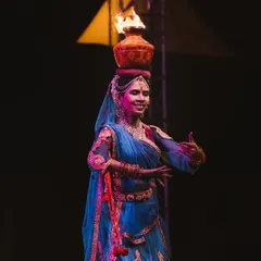 A performer balances a pot of fire on her head during a cultural dance. Capturing the intensity and skill of artists in challenging low-light situations is what I do best, freezing the peak of the action.