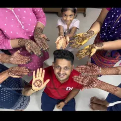 Mehendi is for the whole family. Here's a fun shot with the groom showing his simple initial mehendi, surrounded by the beautifully decorated hands of his family members.