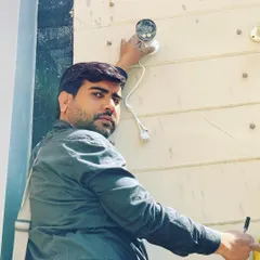 An outdoor camera installation in progress. Our team is trained to work safely and efficiently at any height to secure your building's perimeter.