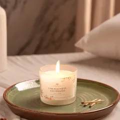 A lit candle in a cozy bedroom setting that we built from scratch in our studio. We can create any interior environment to showcase your products in a realistic lifestyle context.