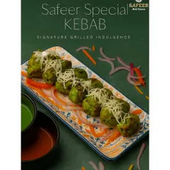 The Safeer Special Kebab is a green, herb-marinated kebab grilled to perfection. It's juicy, flavorful, and topped with shredded cheese, served with mint chutney and a tangy red sauce.