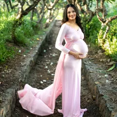 There's something so magical about an outdoor maternity shoot. We found this beautiful tree-lined path in a Mumbai park, and the soft natural light was perfect. This flowy pink gown, which I provide, added just the right touch of fairytale elegance to her solo portrait.