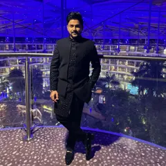 A full-length shot showing how the blue Indo-western outfit is styled. The fit is tailored to be sharp and modern.