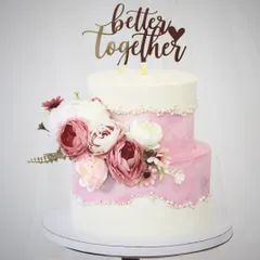 An elegant two-tiered cake designed for a beautiful beginning. The combination of pink watercolor buttercream and clean white tiers is accented with pearl details and a cascade of fresh, beautiful peonies.