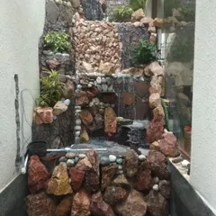 Even a narrow space can accommodate a stunning water feature. I designed and built this vertical stone waterfall to fit perfectly into a wall niche, bringing the sound of water into a compact area.