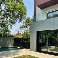 This view highlights the private pool and backyard of the Koramangala residence, where we used clean lines and natural materials to create a serene, private oasis.