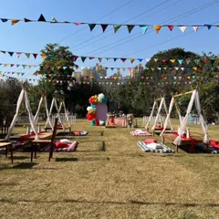 A wide view of our picnic-style birthday setup, with individual teepees and low tables spread across the lawn for a relaxed gathering.