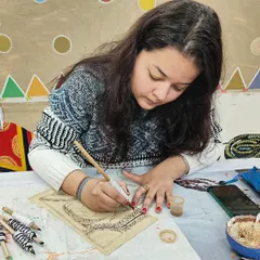 Another student engrossed in her Kalamkari artwork. Our classes provide a quiet, focused space to learn these intricate and historic art forms.