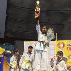 A champion's moment. One of our students stands proudly on the podium after winning at the Open National Taekwondo Championship at Talkatora Indoor Stadium.