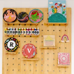 This display wall at my studio is my constant source of inspiration. It's filled with examples of what you can create with my kits, from pour painting and layered art to personalized plaques. Each kit is a piece of this creative energy, sent to you.