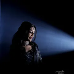 A dramatic, low-key portrait of the bride, using a single spotlight to create a moody and artistic feel.