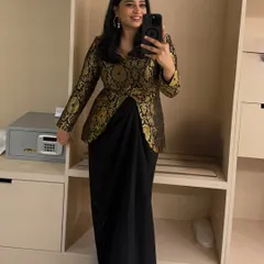 A selfie showing off an elegant black and gold brocade jacket paired with a draped skirt. This is a perfect outfit for hosting a wedding reception or a glamorous cocktail evening.