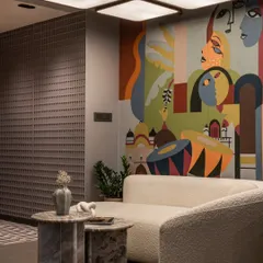 A closer look at the office mural, showing how it coexists with modern furniture and textured walls. The piece is designed to dramatize the space, not just decorate it.
