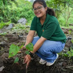 A happy volunteer from Marsh India after planting a Peepal sapling. The joy of contributing to a greener future is evident on her face.