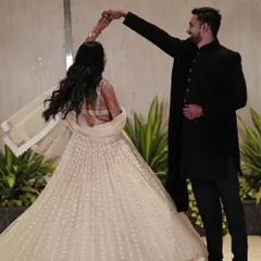 A candid shot of the couple dancing. Her flowing lehenga and simple, elegant hair and makeup allow for beautiful movement and capture the joy of the moment.