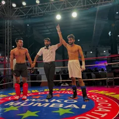 That winning feeling. My student's hand is raised by the referee after a dominant performance in his kickboxing bout.