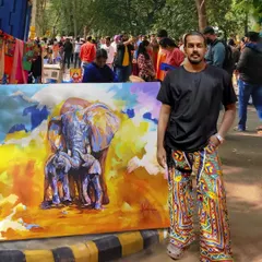 Me with my large-scale elephant painting, 'Mother Love', at an outdoor art fair. This piece, with its abstract colors and emotional theme, always draws a crowd.