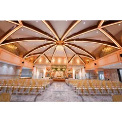 The magnificent, high-arched ceiling of our Kalidas Marriage Hall, designed to give every event a feeling of royal grandeur. This architectural centerpiece ensures your celebration feels as grand as it looks.