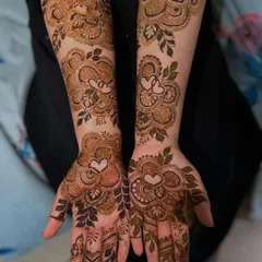 A sweet and romantic design featuring hearts within floral medallions. This is a lovely choice for an engagement, anniversary, or for a bride who wants to add a touch of love to her henna.