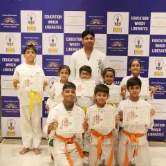 I am incredibly proud to stand with my students from KES International School. This group photo captures the joy and sense of accomplishment after they successfully passed their exams for new belts and received their certificates.