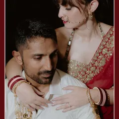 A close, intimate portrait of a couple in Jammu. The bride, adorned with traditional jewelry, embraces the groom from behind, creating a powerful and emotional image.