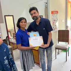 A proud student receiving her certificate of completion. We celebrate every milestone in our young actors' journeys.