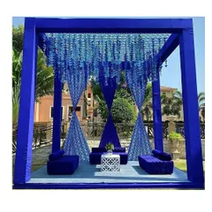 Inspired by the elegance of blue pottery, we designed this unique mandap. The deep blue structure, combined with hanging floral strings, created a serene and sophisticated ambiance for a daytime ceremony.